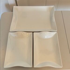 Set of 3 stackable white porcelain serving platters.